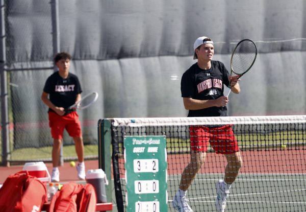 Jacob Devlin, 11, and Juan Guevara, 9, play together in a doubles varsity match. 