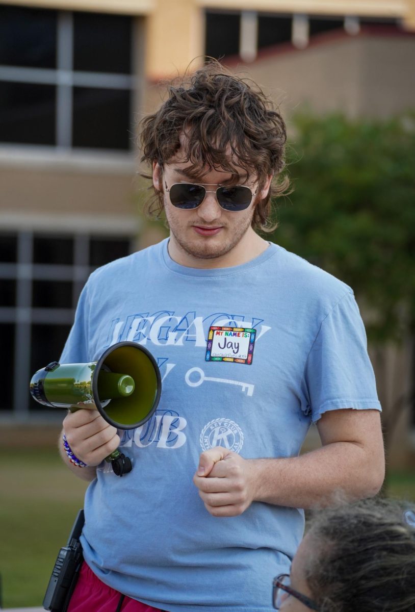 Before the race begins, Jay Hillis, 12, guides a participant to the handicap run. Key Club offered both a handicap race and race for attendees.
