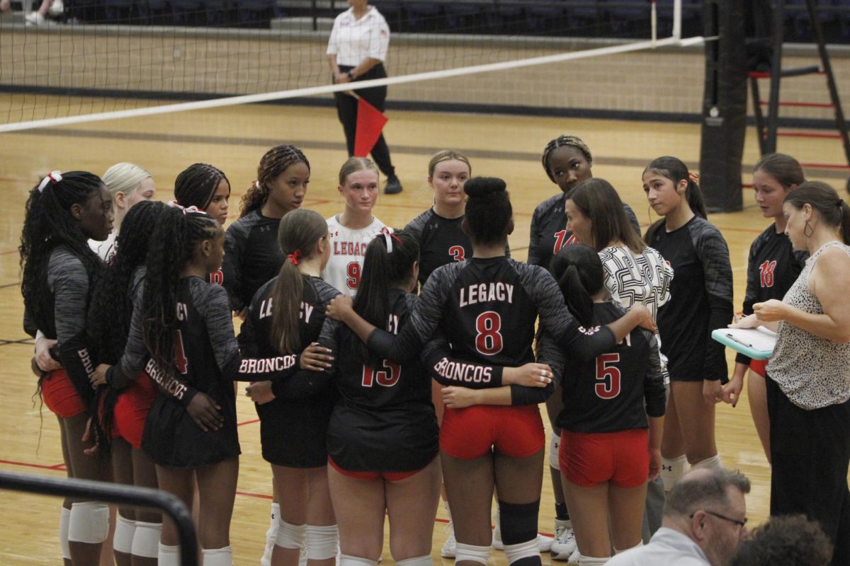 During a timeout, the team huddles and listens to coach on a game against Burleson on Aug. 27 Varsity volleyball won the game 3-2 .  