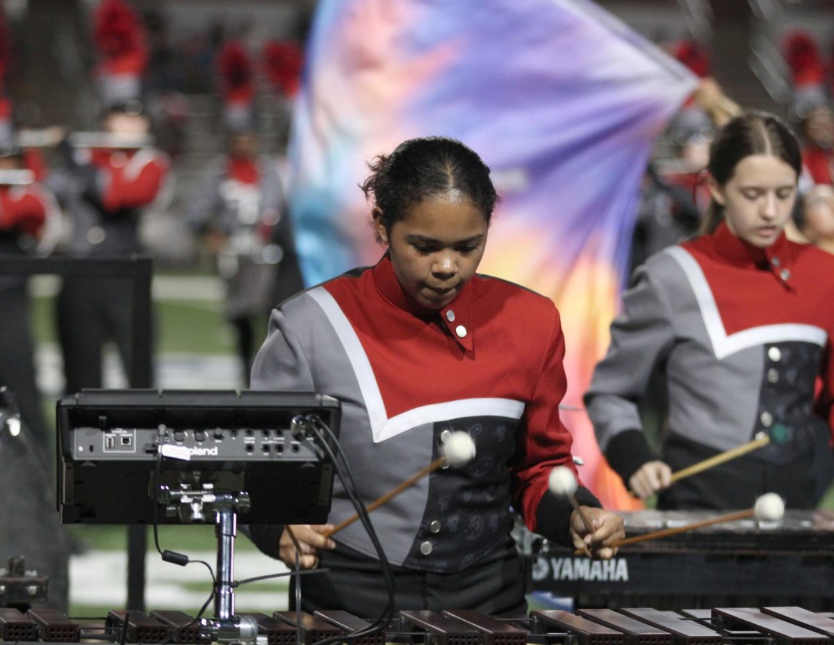 Kayden Lewis, 11, plays percussion during the blackout game's halftime show at Newsom Stadium.