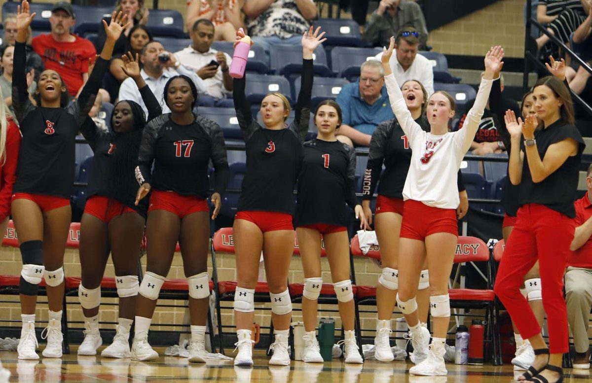 Varsity volleyball celebrates a point scored against Lamar on Aug. 20. They won 3-0.