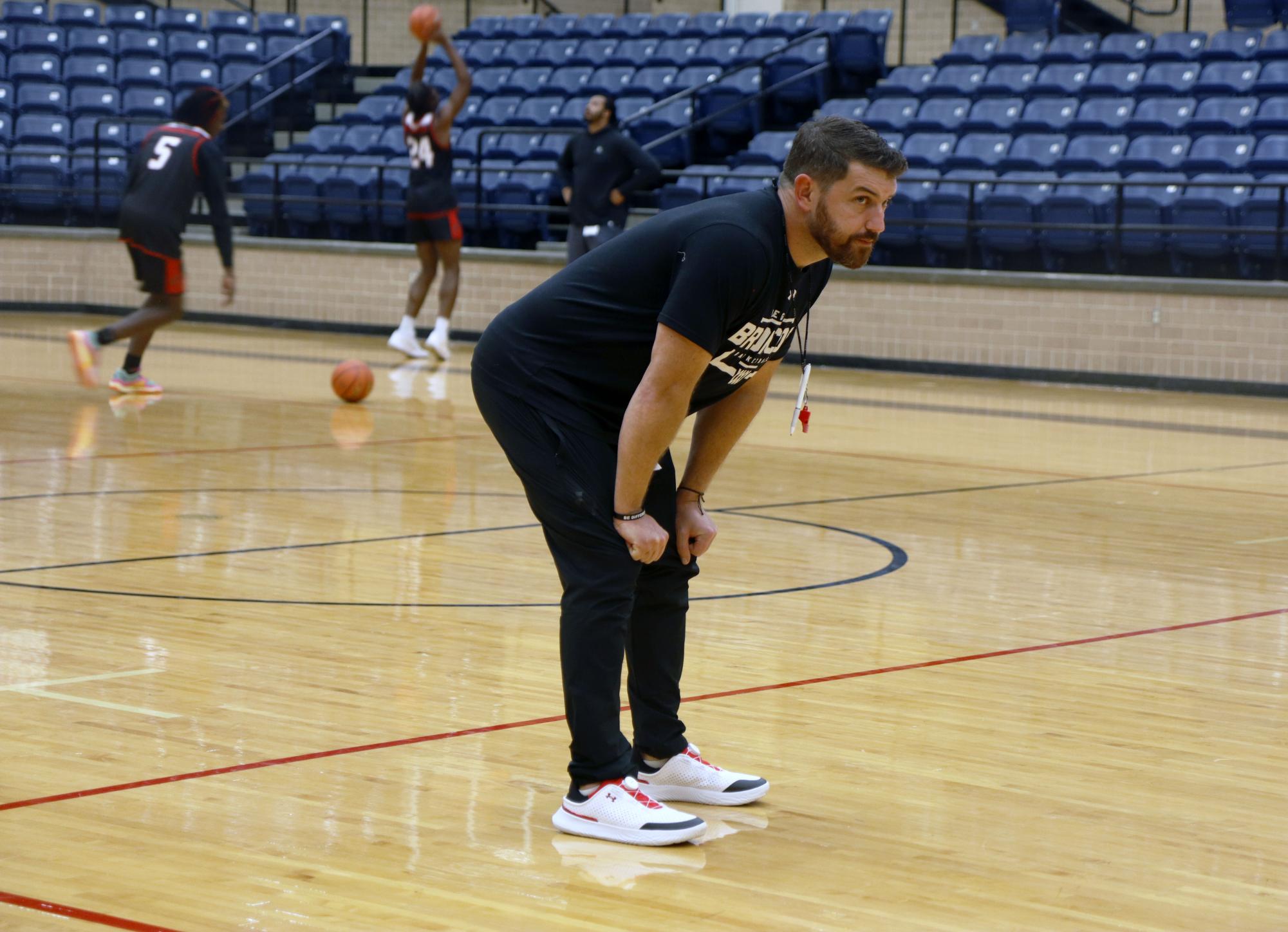 Head boys basketball coach Ben Kinnison leads varsity practice on Sept. 23.