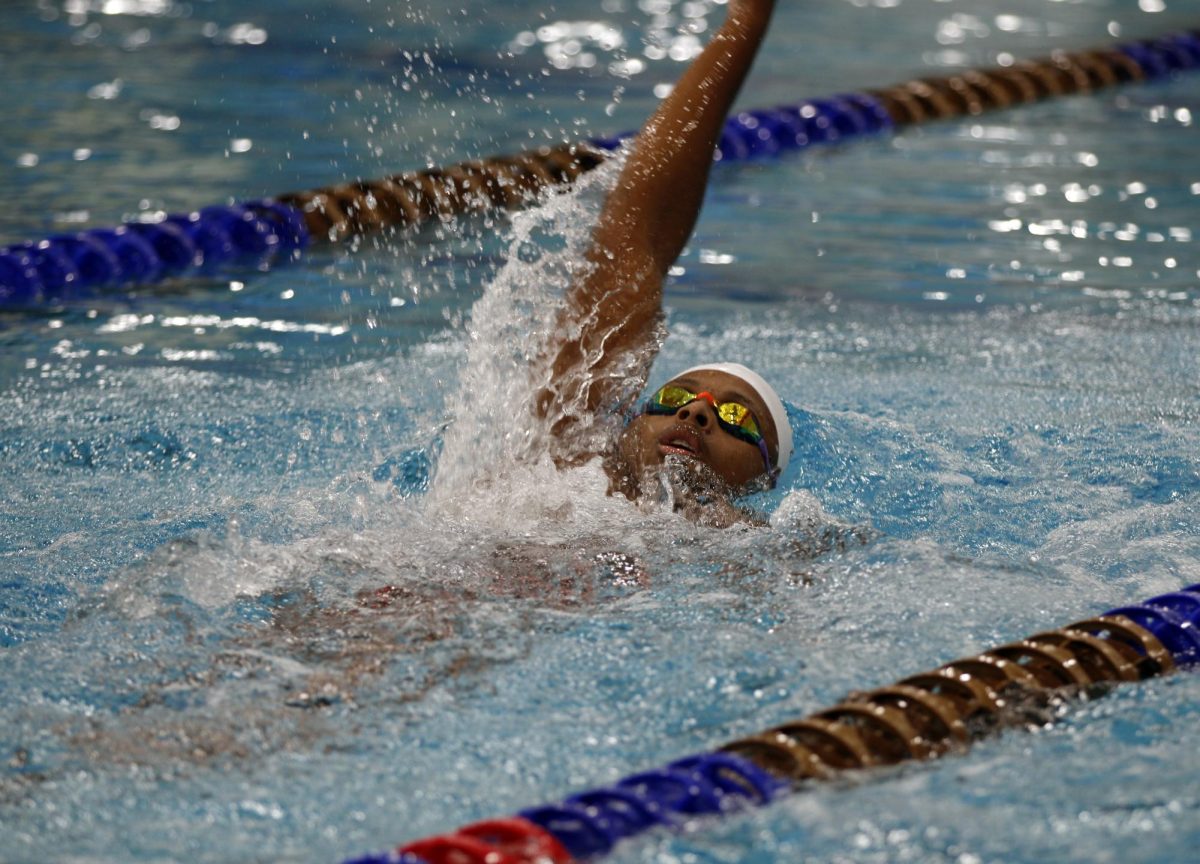 Chandler Garrett, 12, swims at varsity practice.