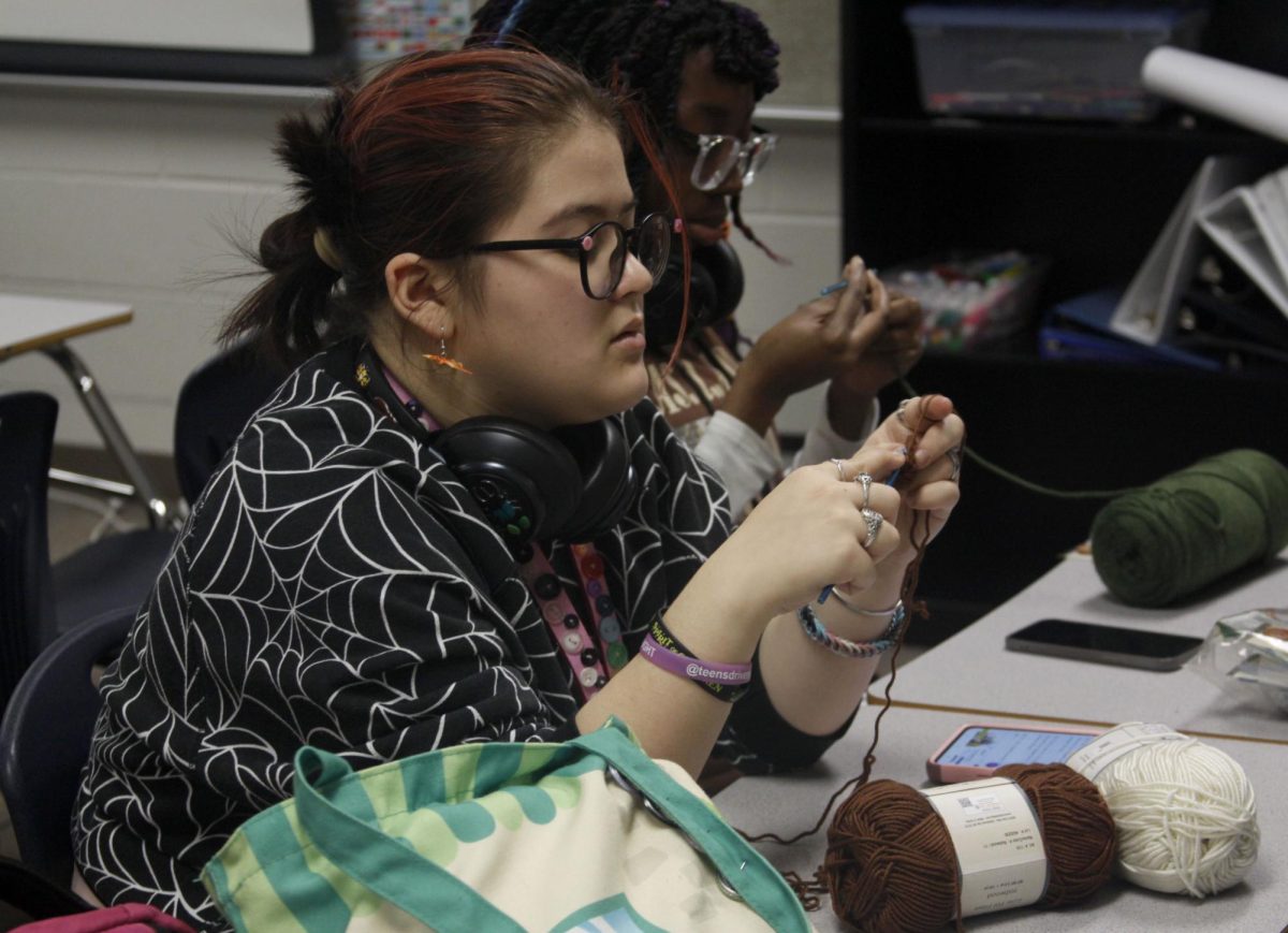 In after-school crochet club, Jade Clark, 11, carefully threads the string. The Crochet club is held every Thursday on the second floor in room S203 where students can meet and crochet and craft together.