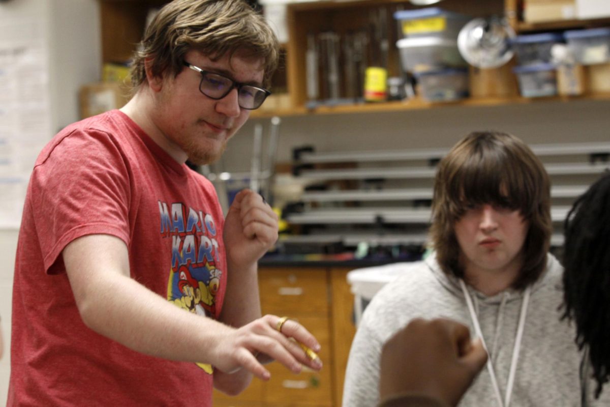 In gaming club, Haiden Turner, 11, explains how the round proceeds to his participants. Gaming club meets together every Tuesday in room T219 to play various games.