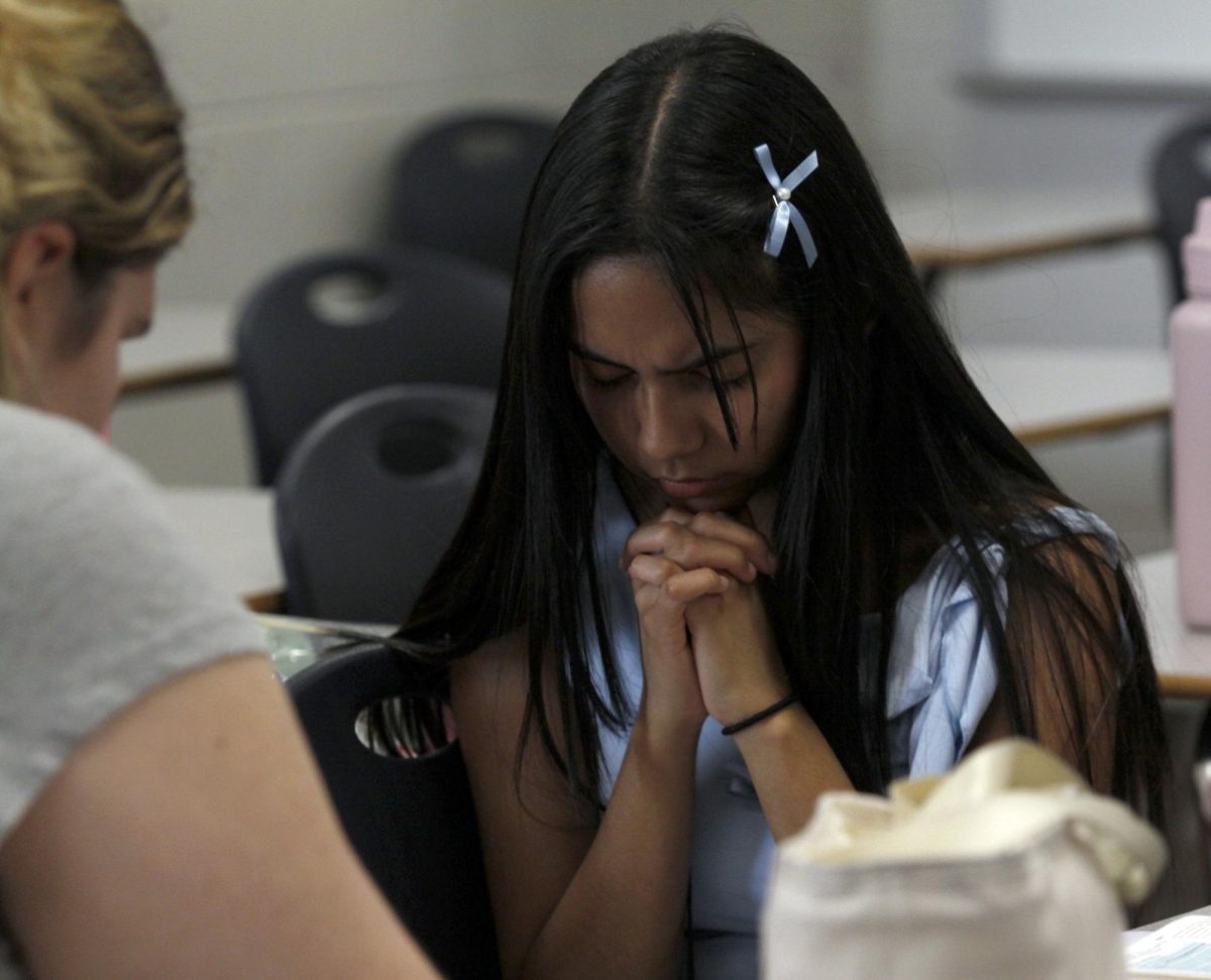 At Jesus Club, Dayanara Altamirano, 10, gives her prayers. Jesus Club meets every Tuesday on the first floor in room AJ101. 