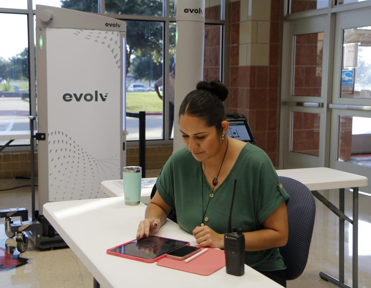 The new Evolv Monitor, Victoria Aguirre, manages the Evolv System. Students can now hold Chrome books above their heads to go through the system. "It's a successful way to get students through quicker and more efficiently and has been doing well since the APs introduced this concept to me on Monday," she said.