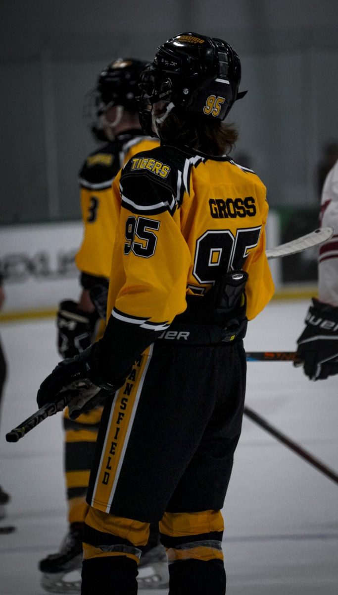 Sophomore Quentin Gross listens to his coach after the first period during a Mansfield Varsity Silver game on Oct. 9. They won 7-4 against Birdville. 