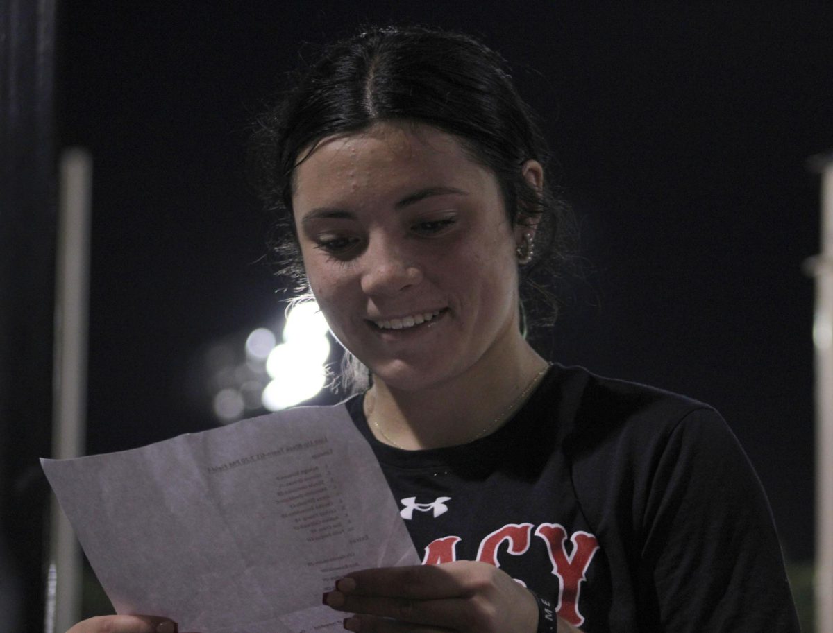 Lillie Gaudio, 10, reads a list aloud to the team of that will be hitting the ball at the first softball scrimmage of the year against Martin.