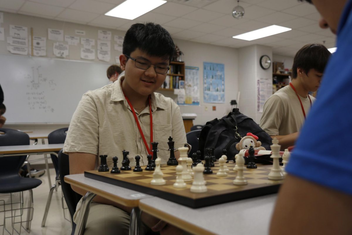 Aland Ung, 10, plays chess on Sept. 10. Chess club and gaming club merged this year to create a larger environment.