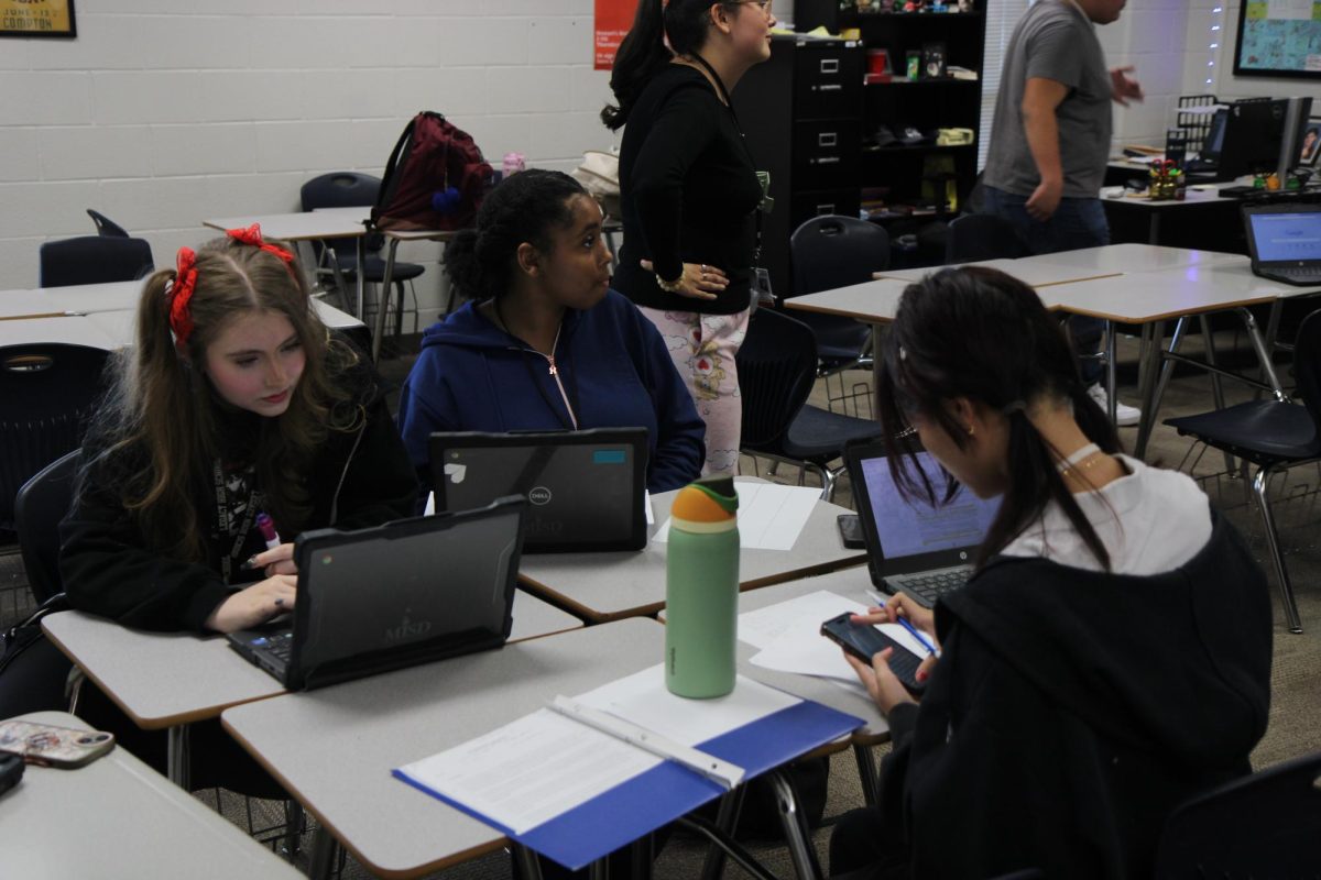 President, Shophia Whittler, 12, works with the new members to find new topics. They had to go online and find information about new topics to discuss for the club