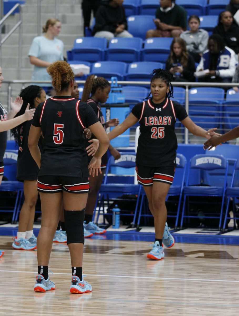 As Janai DeJesus, 10, gets announced as starting guard after she got hurt last game on Nov. 1, and Laila Holmes, 12, and DeJesus do their handshake they do before every game.
