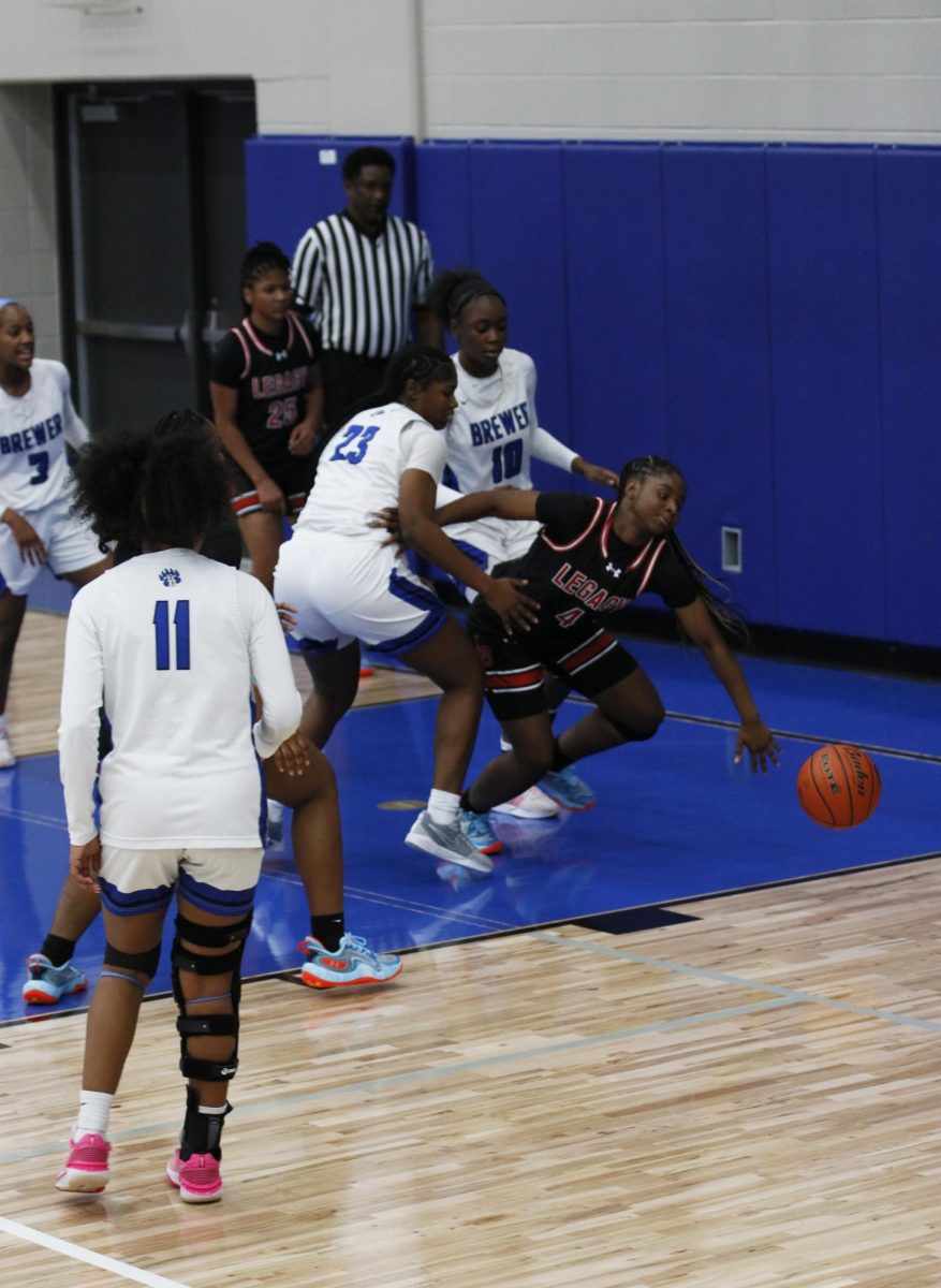 As Dahlia Wright, 10, goes up for the rebound, she comes down and stumbles. Wright managed to dribble to reset the play.