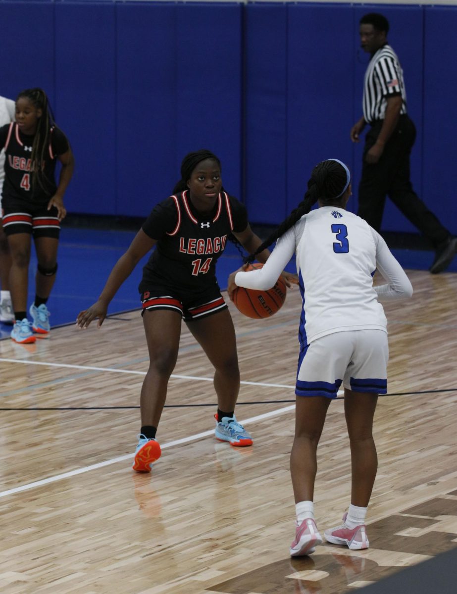 While in the fourth quarter, Eyimofe Olawepo, 12, waits to see what her opponent will do next.
