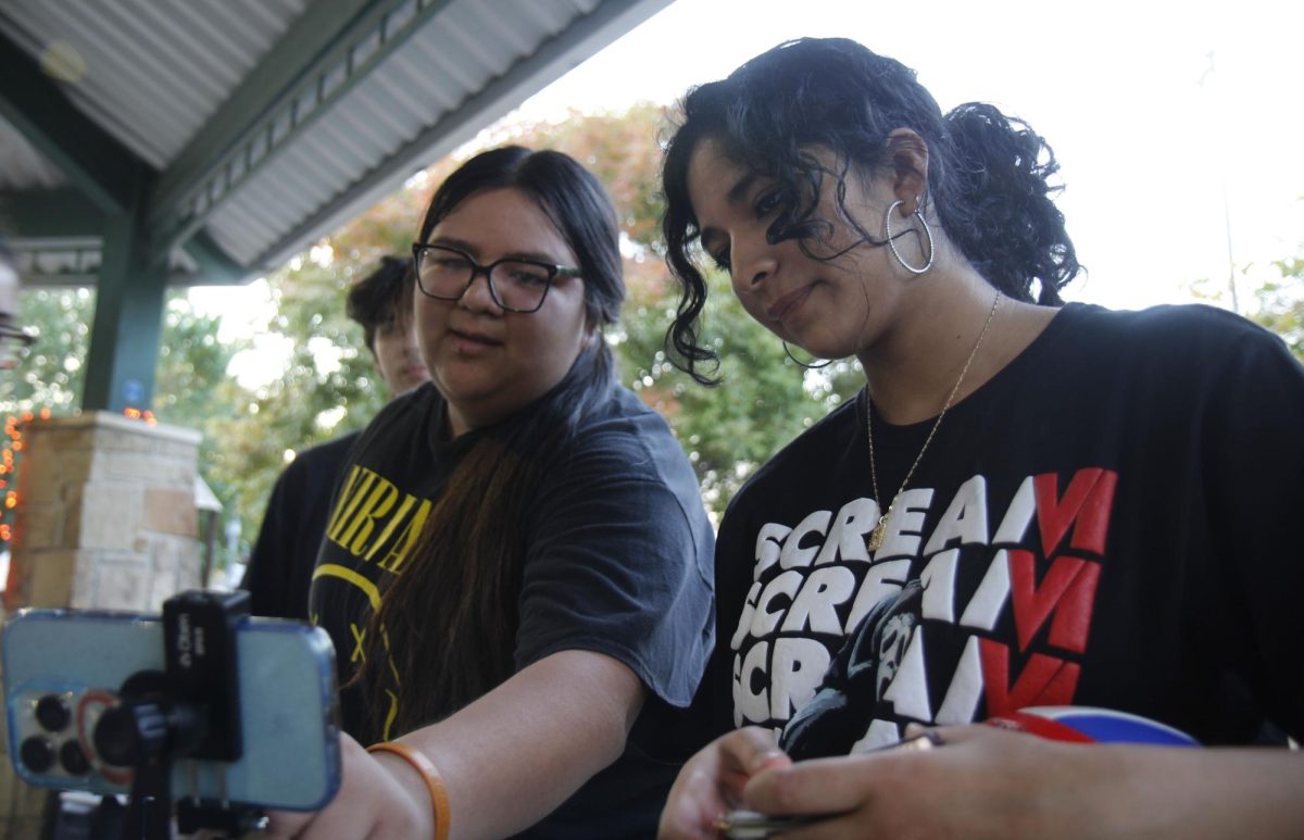 Seniors Maria Limas and Jacquelin Sanches look at a time-laps of their work, "It was really cool to see our process," Limas said "[It] didn't feel like we spent so much time working on [the pumpkins]."
