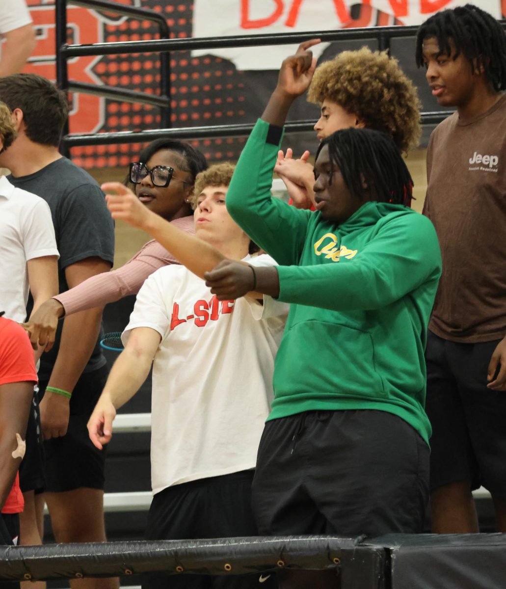 At the volleyball game Grant Reser, 12, and Khali Sanogo, 11, celebrate a kill that gave them the lead in the set.