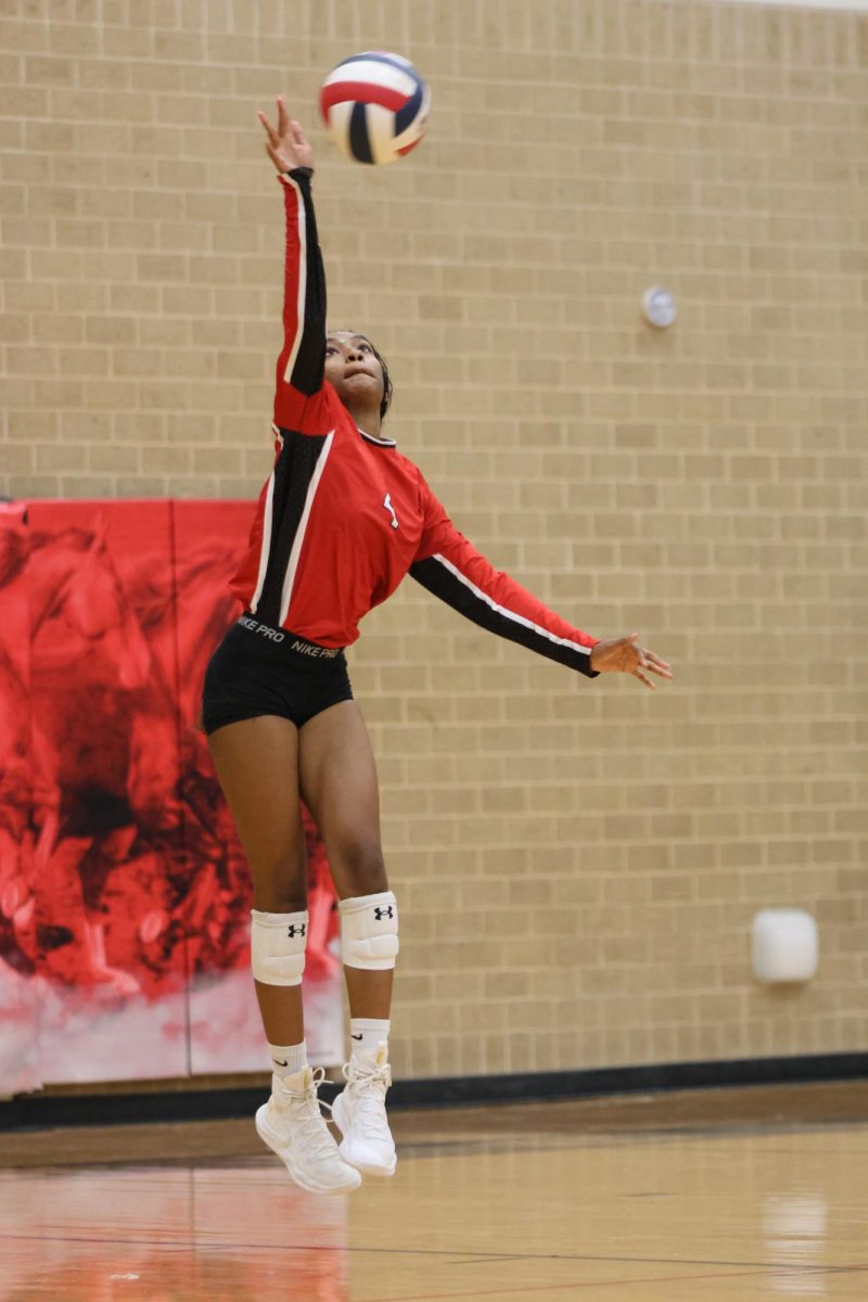 At the start of the third set, Kalani Davis, 11, serves the ball to Boswell.