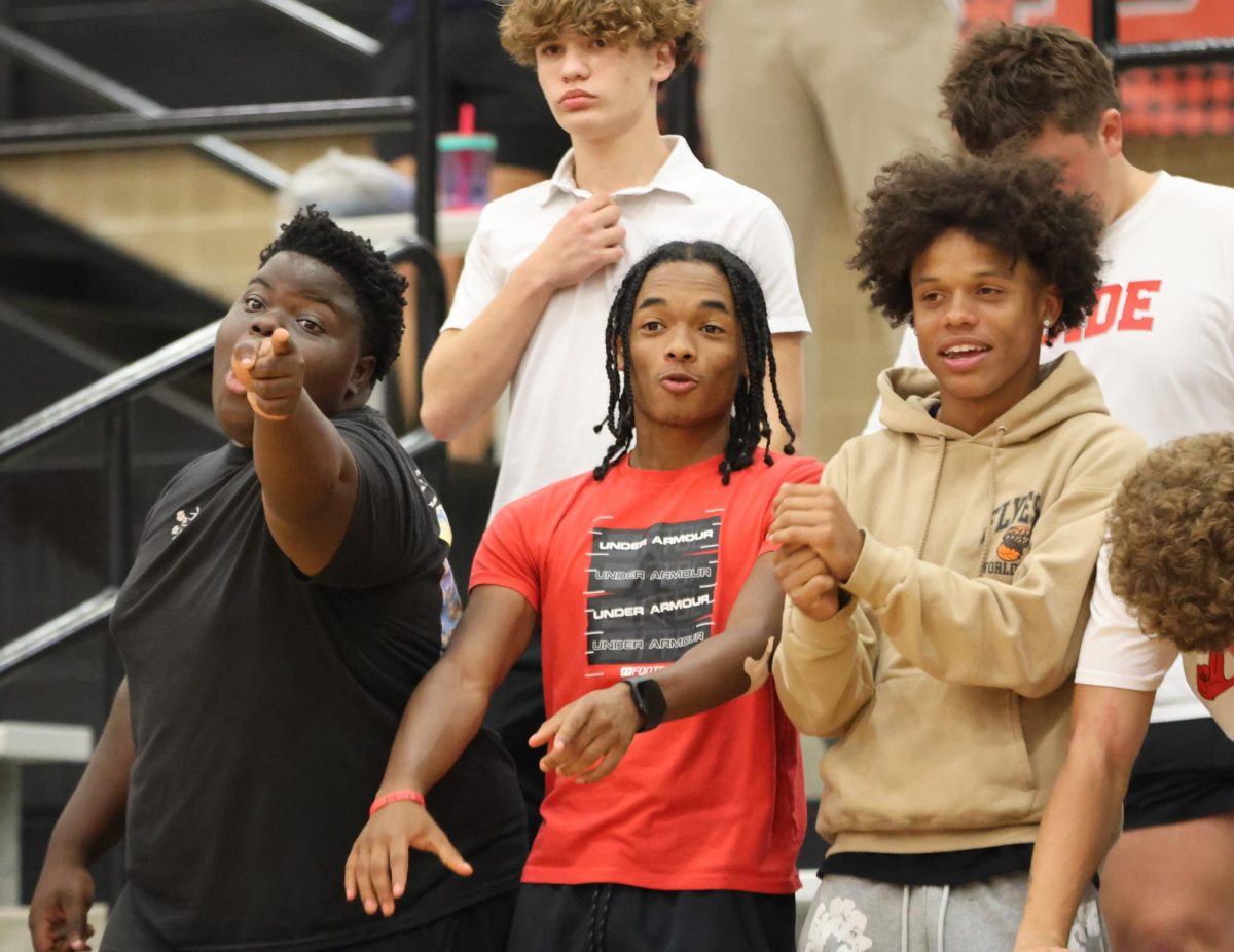 During the volleyball game D’Andre Thomas, 11, Jackson Carr, 12, and Hector Bedu-Addo, 12, celebrate after a block. This put them up in the set 21-19.