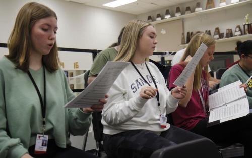 Juniors Emmie Powel, Jadyn Jordan and Annalise White warm up their voices during choir class. Choir practiced their list of music for their upcoming winter concert. 