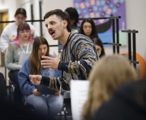 Mr. Max Vrij directs choir students as they rehearse during fifth period. Mr. Vrij joined Legacy as the assistant choir director after student teaching last year. 