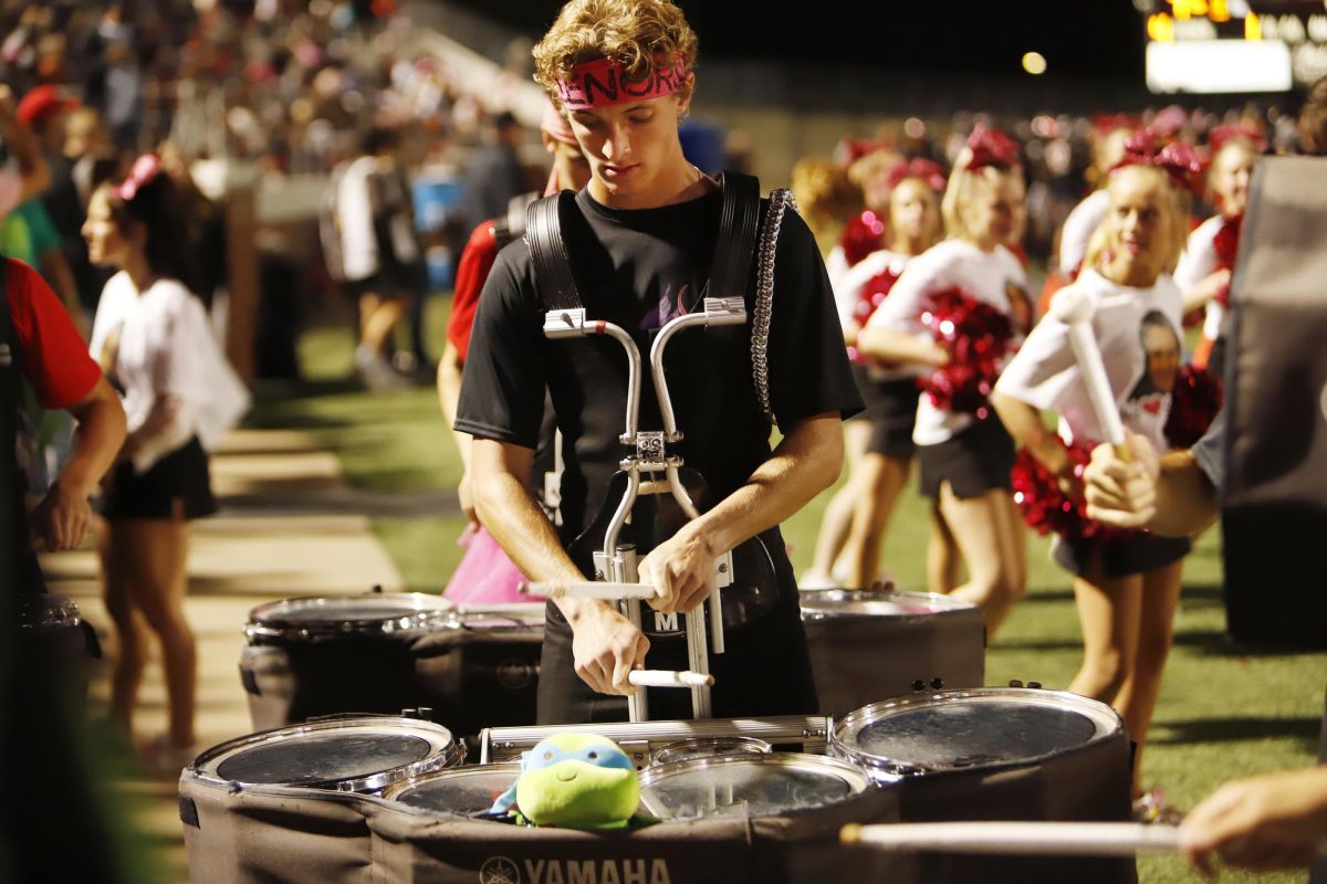 Ty Gery, 12, performs during football game against Mansfield.