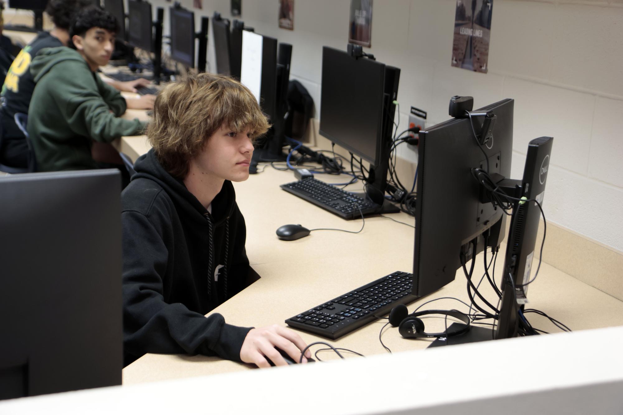 Keenan Schrack, 11, works during Photojournalism on April 3. 