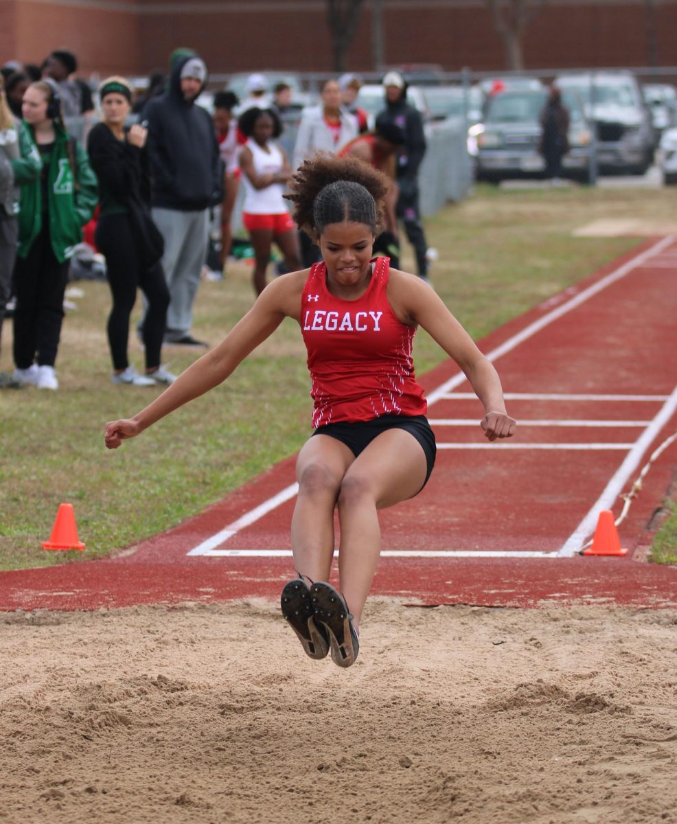 Sophomore Maya Richards triple jumps during the track meet on Feb. 14. She advanced to area in this event.