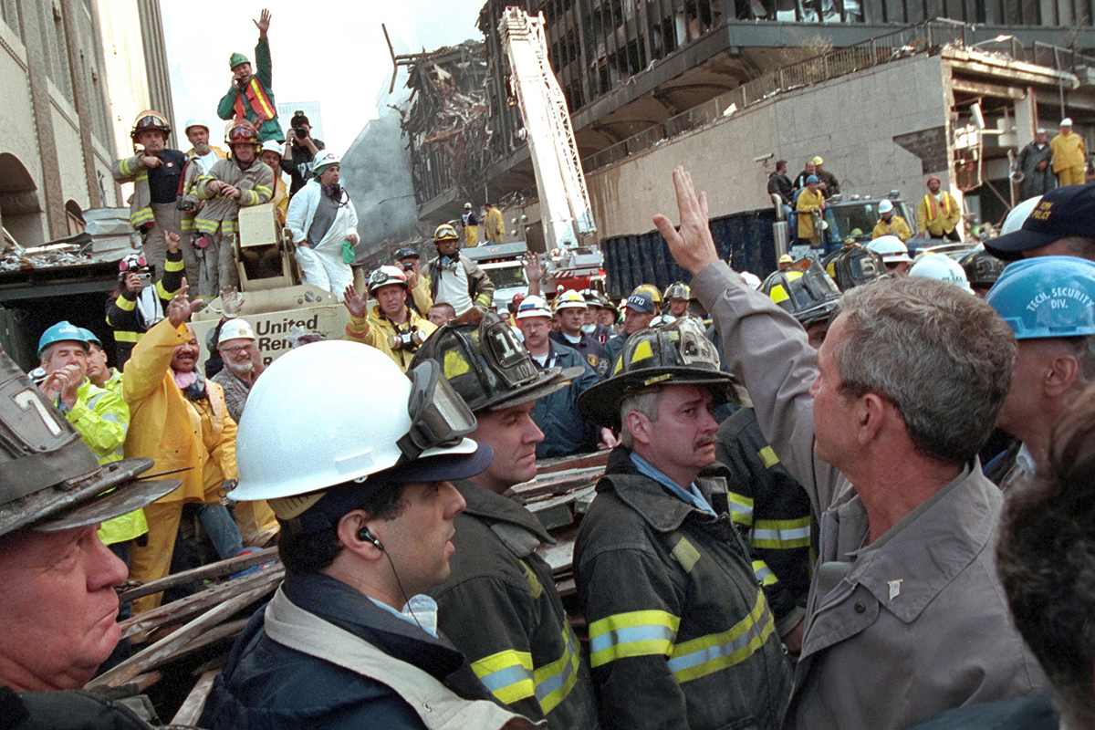 President George W. Bush waves to a rescue worker Friday, Sept. 14, 2001 while touring the site of the World Trade Center terrorist attack in New York City.  Photo by Eric Draper, Courtesy of the George W. Bush Presidential Library