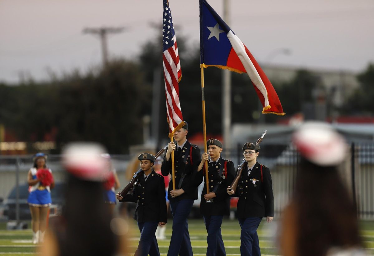 JROTC Color Guard walks across the field as Legacy prepares to play Boswell on October 9. 