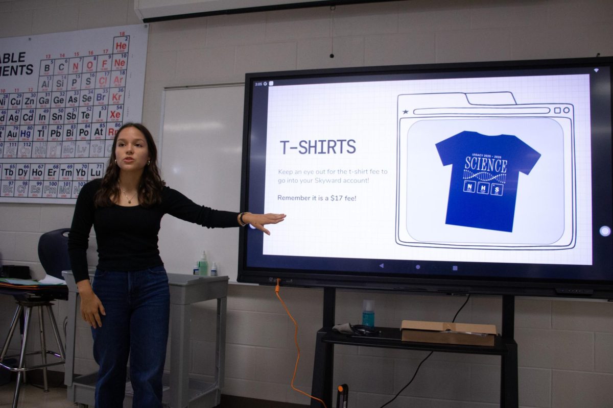 During the SNHS meeting, Katelyn Castro, 12, talks to members about ordering shirts. SNHS meets every third Wednesday of the month.