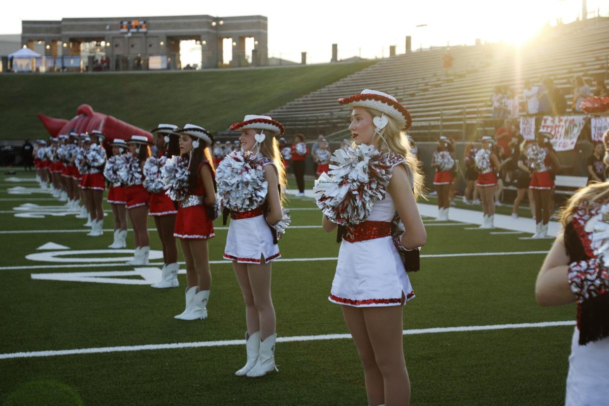 Molly Aldridge, 12, stands in line with the Silver Spurs before the South Grand Prairie game. 