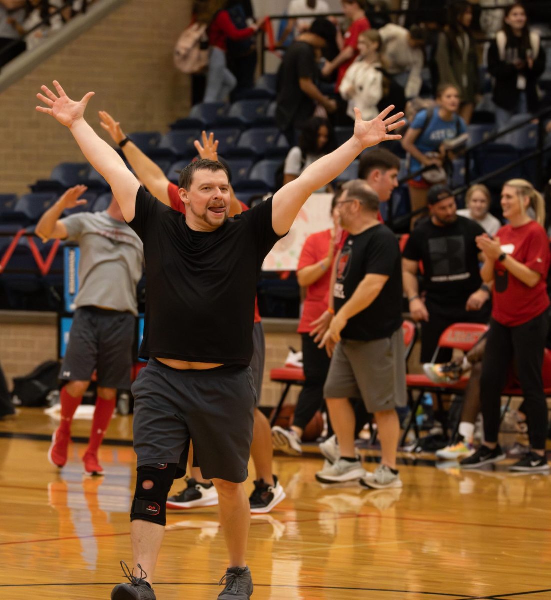 Teachers school the students:
Mr. Gerad Jackson celebrates winning the teachers vs. students basketball game. The faculty won, 24-23.