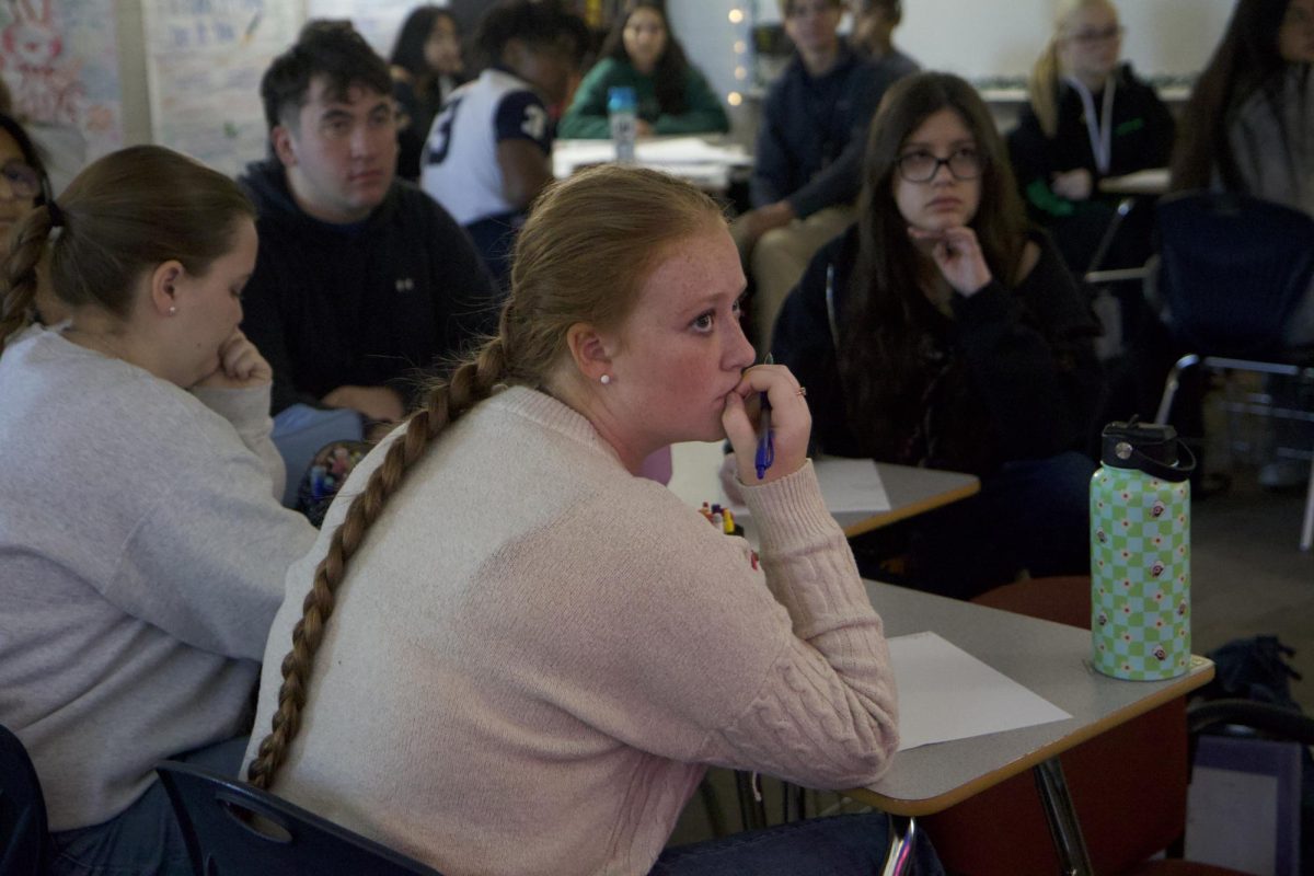 Audrey Osburn, 11, takes notes during Ms. Alexandra Kim's AP English III class. 
