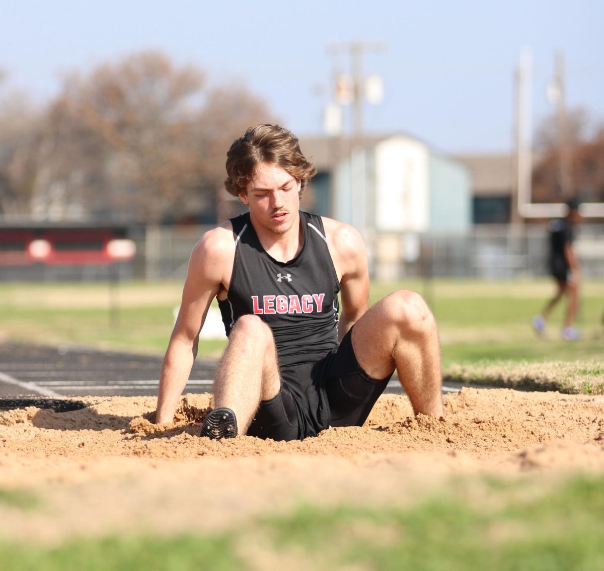 Wyatt Hitt, 11, lands in the sand after his long jump.