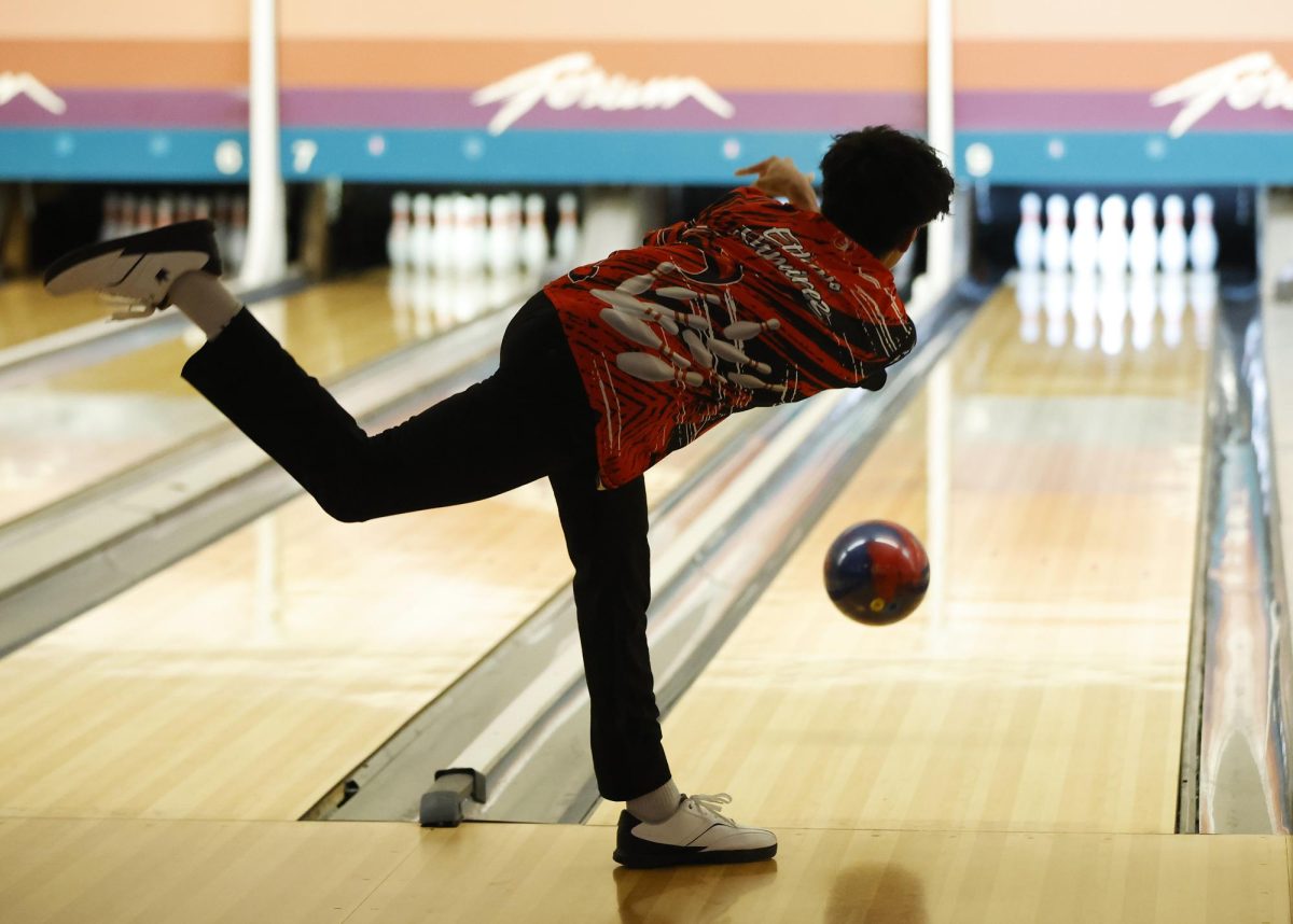 During the bowling match on Feb. 5, Ethan Ramirez, 12, watches his ball swiftly approaches the pins.