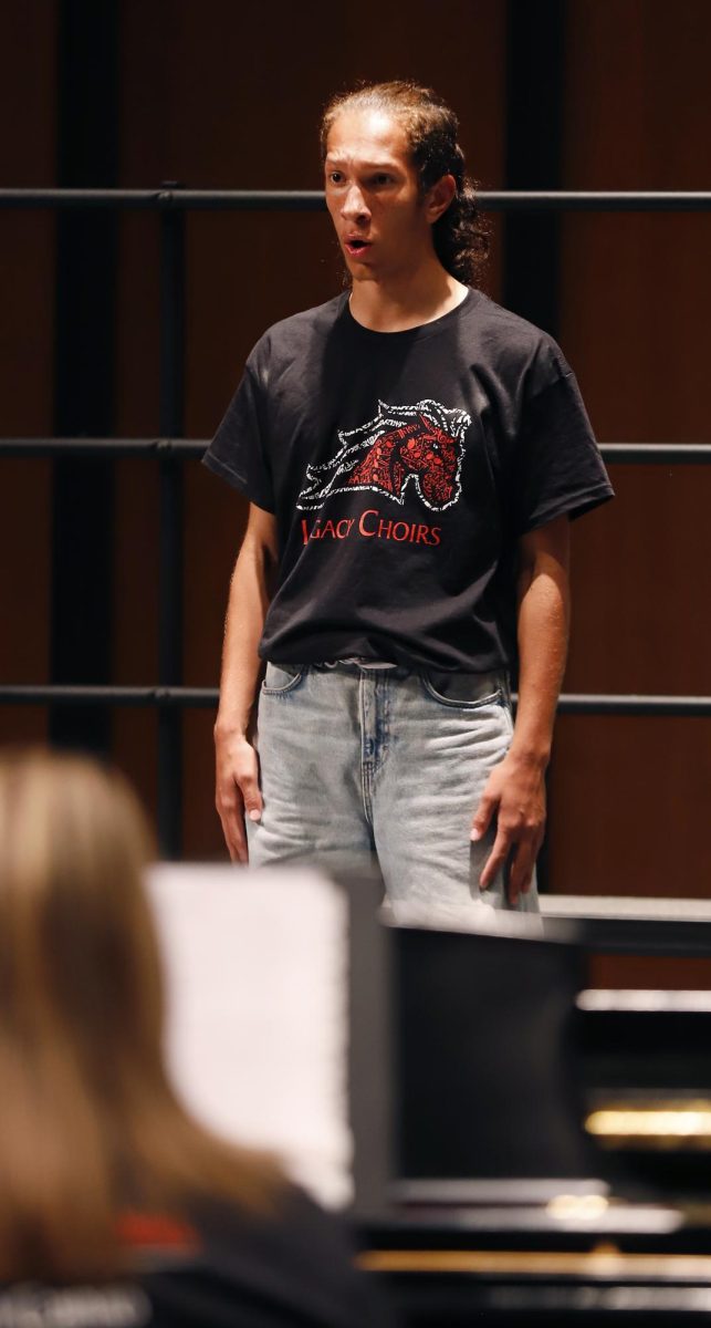During the choir fall concert, junior Tyson Frank sings with the Chamber choir. 