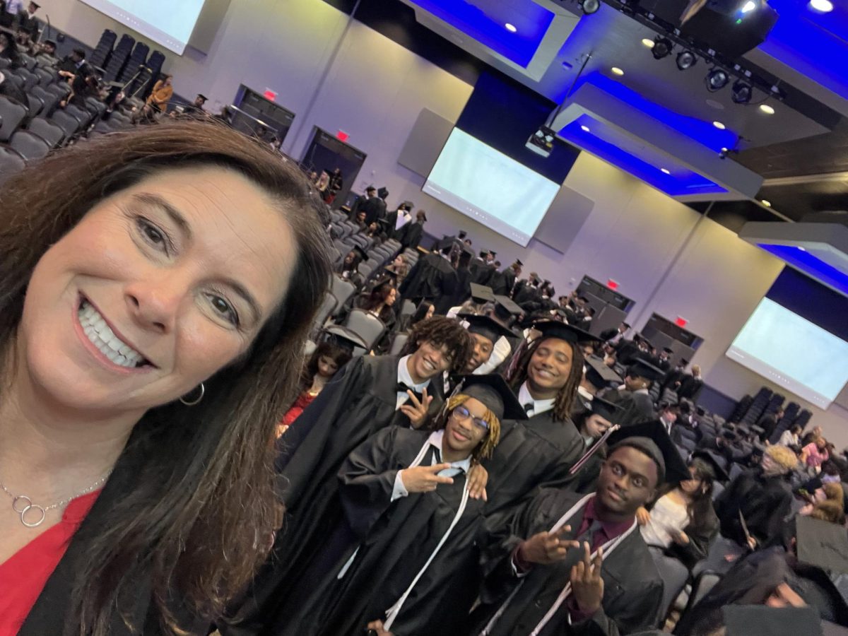 Dr. Stephanie Bonneau takes a selfie with the graduating class of 2024. 