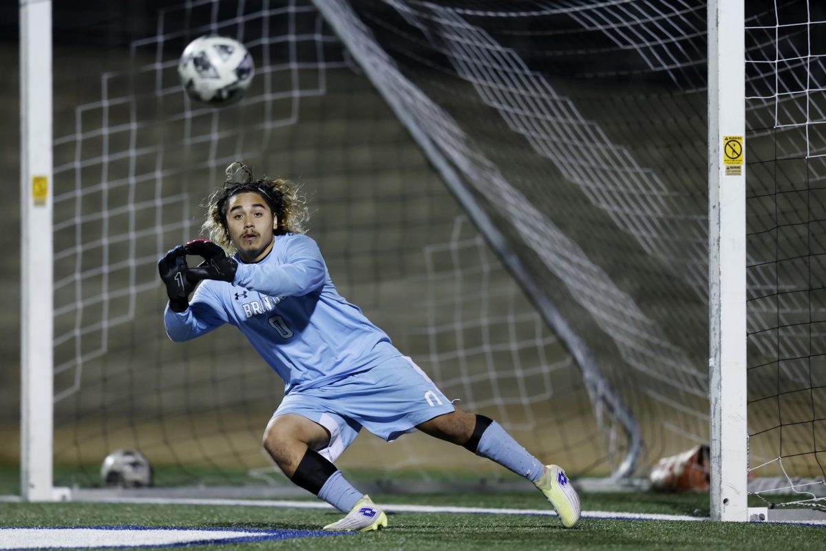Reaching out, senior Angel Aguilar saves the ball from the goal. Soccer played Boswell Feb. 24 and won 4-1.