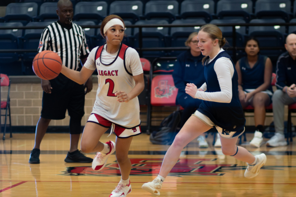 During the girls' basketball scrimmage Nov. 5, senior Maddie Crawford dribbles the ball toward the goal. Crawford recently scored her 2200th point, shattering Legacy’s previous point record set in 2023.