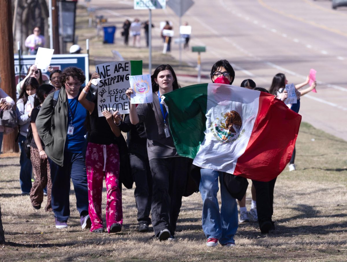 Sophomore Juan leads the walkout from Legacy as the students walk down North Main Street. The walkout began Feb. 12 at 1:20 p.m.