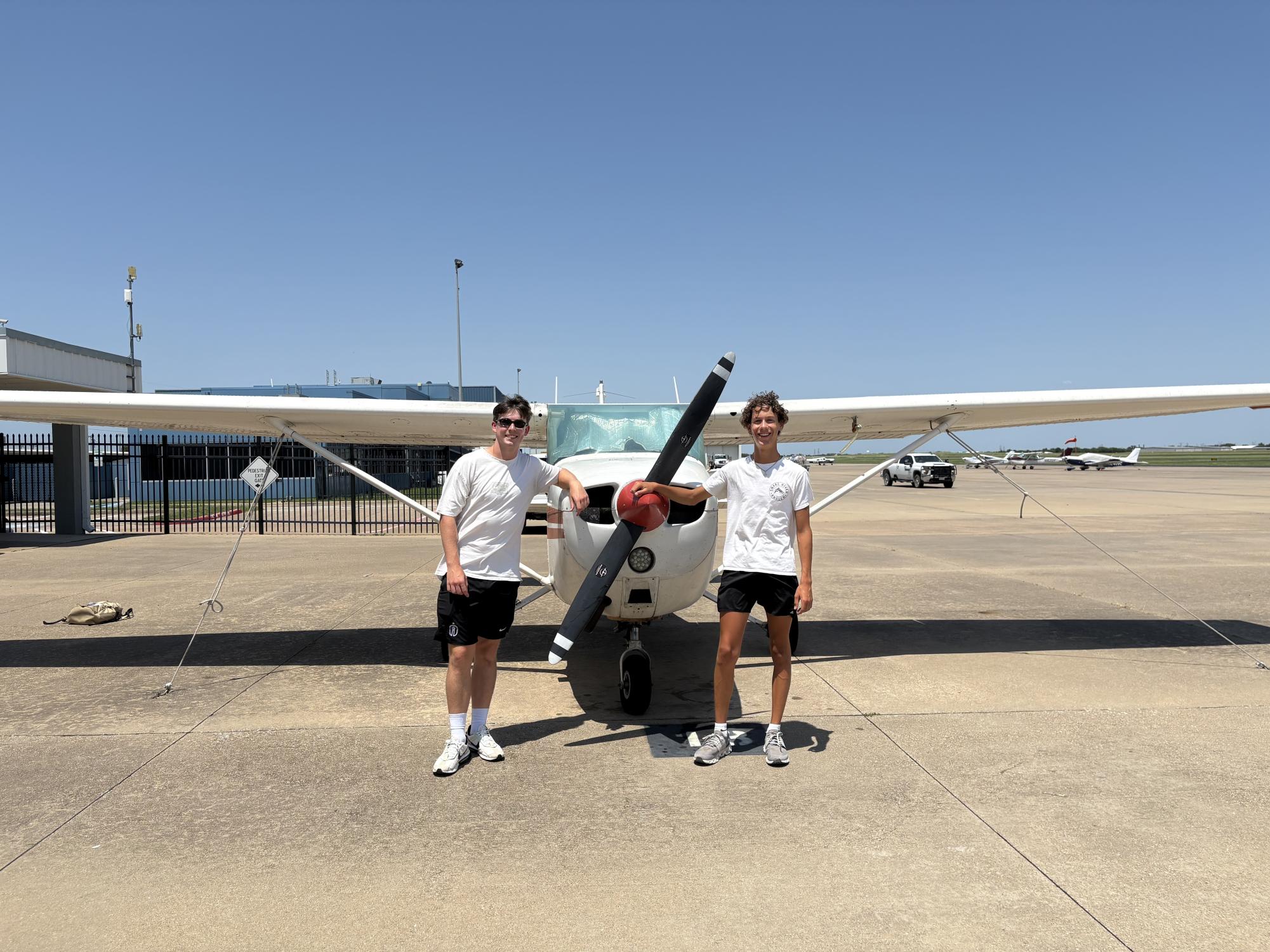 Bowen Knox, 12, stands with his flight instructor, Michael Somerville, in front of the plane he completed his first solo in on Aug. 8.