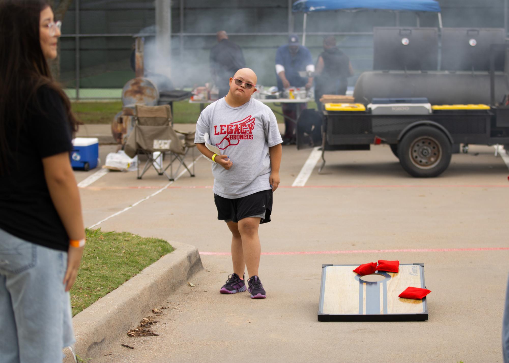 During the FALS field day, Madison Leyva, 10, plays cornhole. Throughout the field day participants play different games and eat grilled food. 