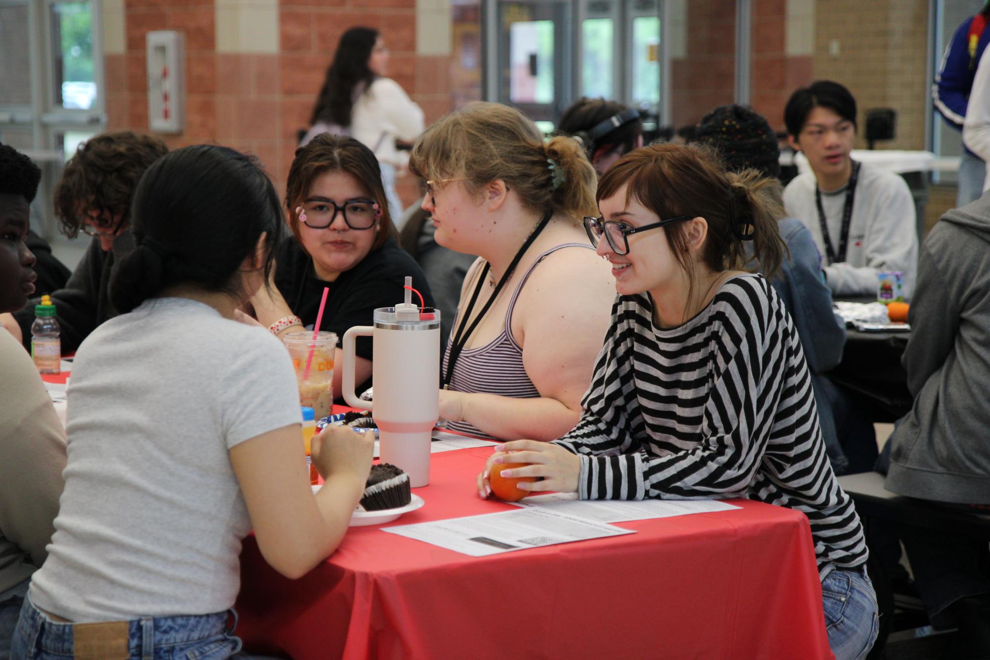 During Senior Breakfast on April 15, Liliana Teran, 12, eats and chats with her friends.