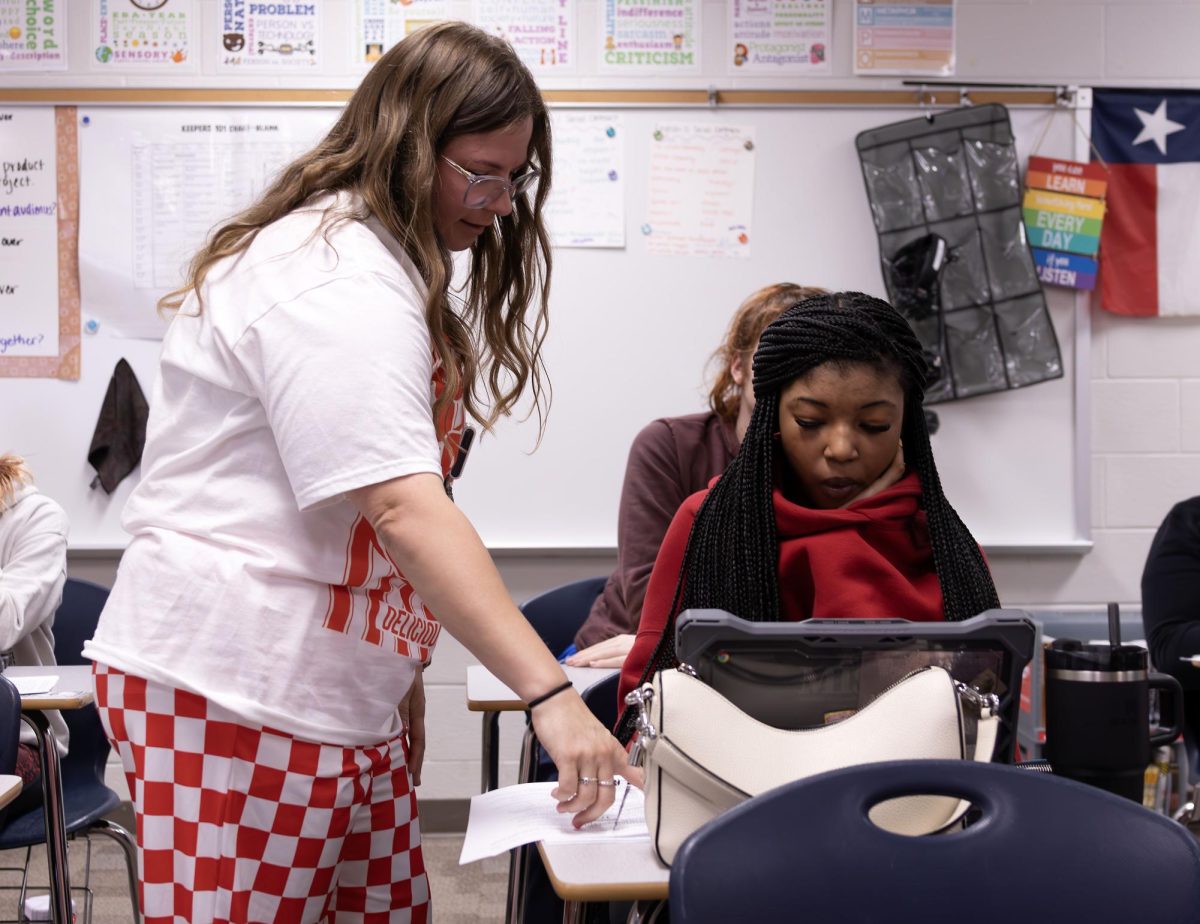 Ms. Mata works with a student during second period. Ms. Mata teaches English I and II at Legacy.